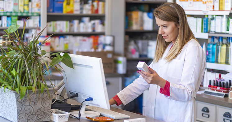 Female pharmacist working in chemist shop or pharmacy. Pharmacis