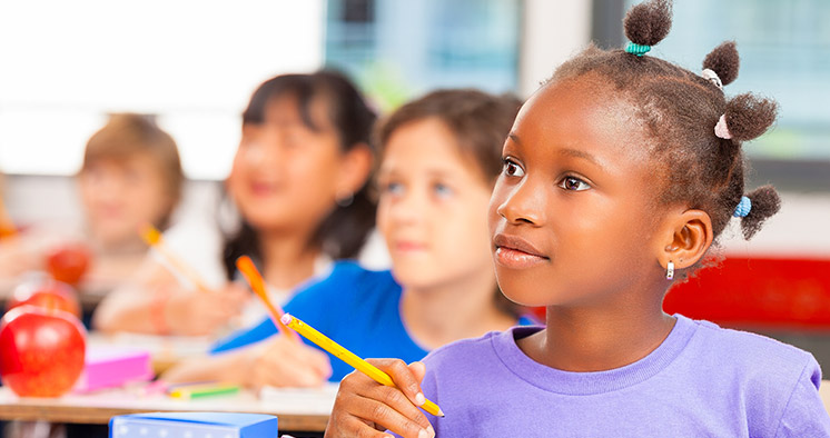 Happy children in a multi ethnic elementary classroom
